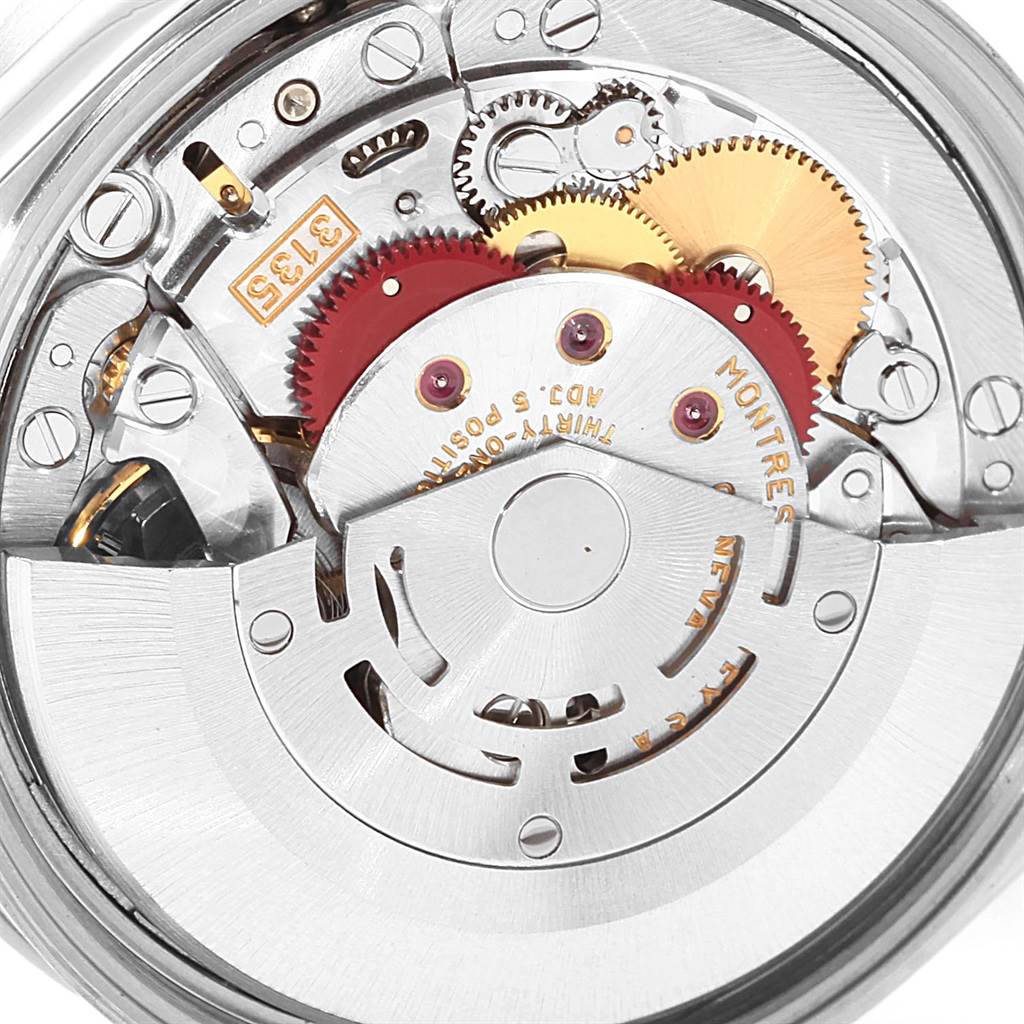 The image shows the movement and mechanism of the Rolex Date 15210 Men's Stainless Steel Blue Dial 15210 Men's Stainless Steel Blue Dial watch, highlighting gears and intricate internal parts.