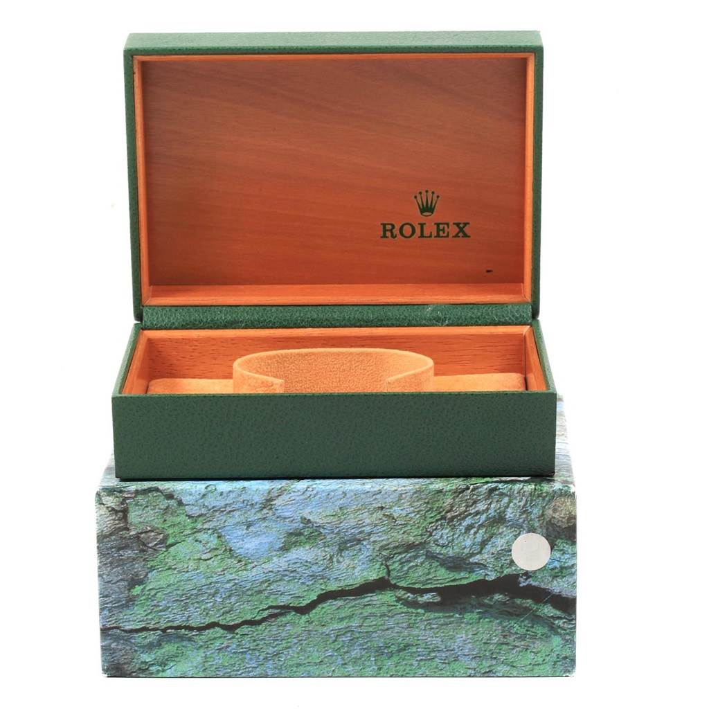 The image shows an open green Rolex Date 15210 Men's Stainless Steel Black Dial 15210 Men's Stainless Steel Black Dial model watch box with a wooden interior.