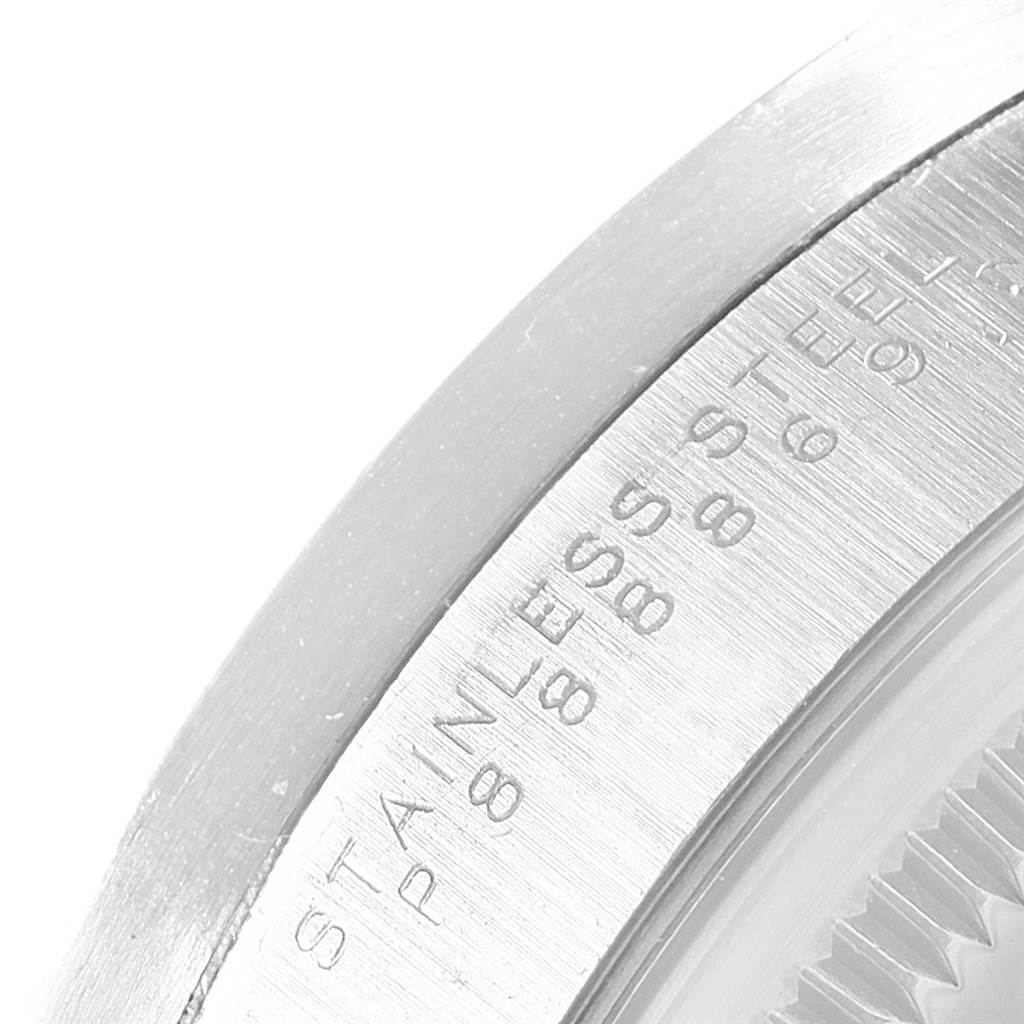 This image shows the side view and part of the case back of a Rolex Date 15210 Men's Stainless Steel Black Dial 15210 Men's Stainless Steel Black Dial model watch, highlighting the stainless steel engraving.