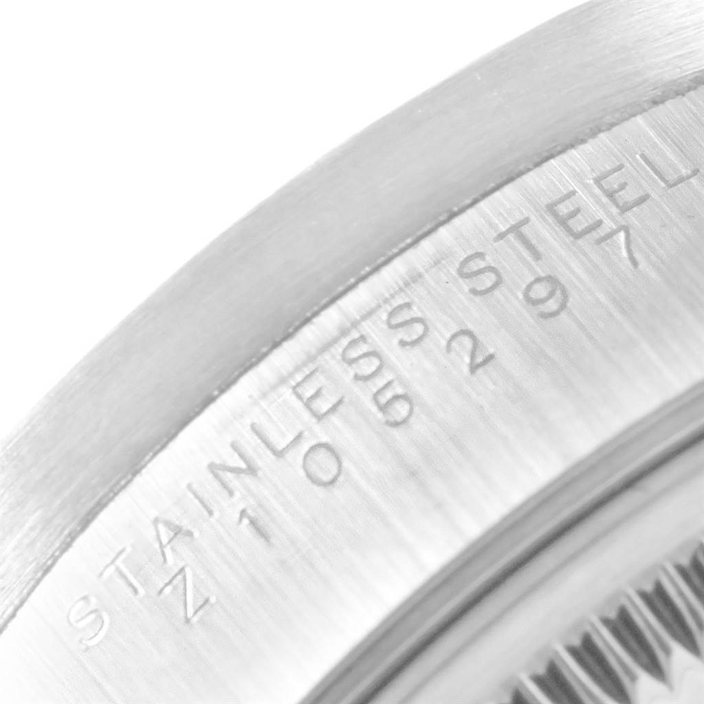 This close-up image shows the stainless steel case back of a Rolex Date 15210 Men's Stainless Steel Silver Dial 15210 Men's Stainless Steel Silver Dial model watch, featuring engraved details.