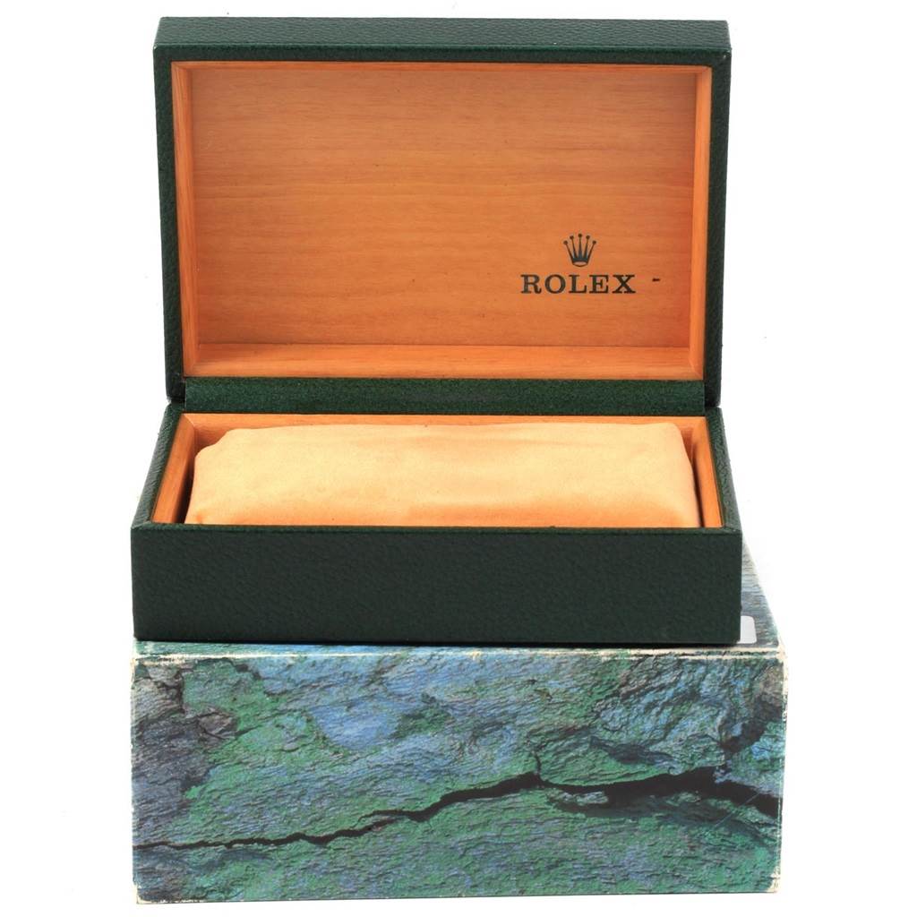 This image shows an open green and wooden Rolex box for a Date model watch, positioned straight-on.
