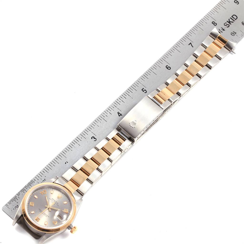The image shows a Rolex Date 15203 Men's Steel and Gold (two tone) Grey Dial 15203 Men's Steel and Gold (two tone) Grey Dial watch laid flat, with a metal ruler measuring its length.