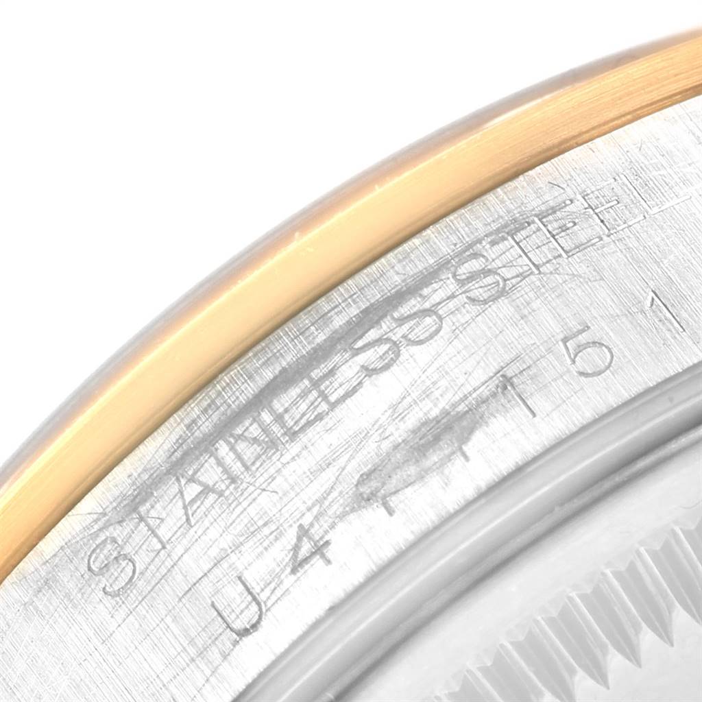 This is a close-up angle of the casing and engraved serial number on the Rolex Date 15203 Men's Steel and Gold (two tone) Grey Dial 15203 Men's Steel and Gold (two tone) Grey Dial model watch.