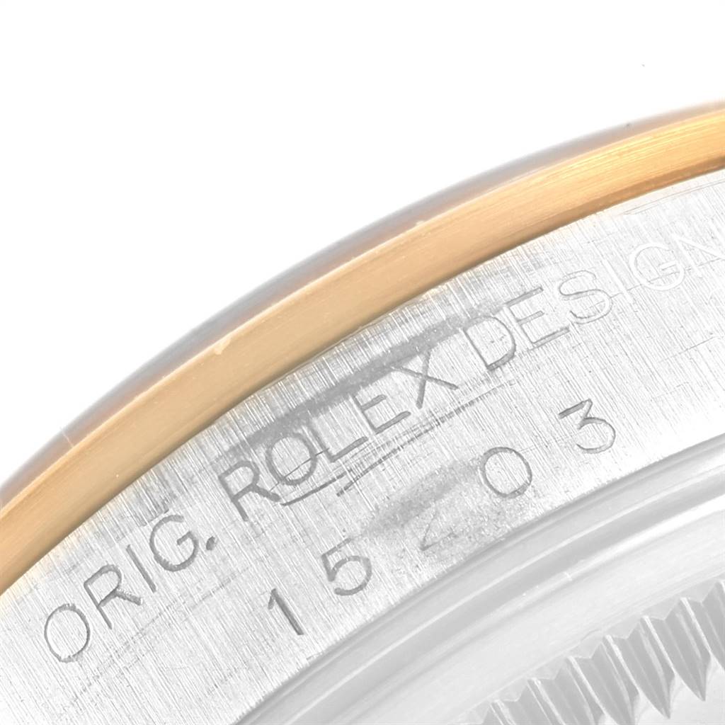 This image shows a close-up of the case back of a Rolex Date 15203 Men's Steel and Gold (two tone) Grey Dial 15203 Men's Steel and Gold (two tone) Grey Dial model, highlighting the model number and brand inscription.