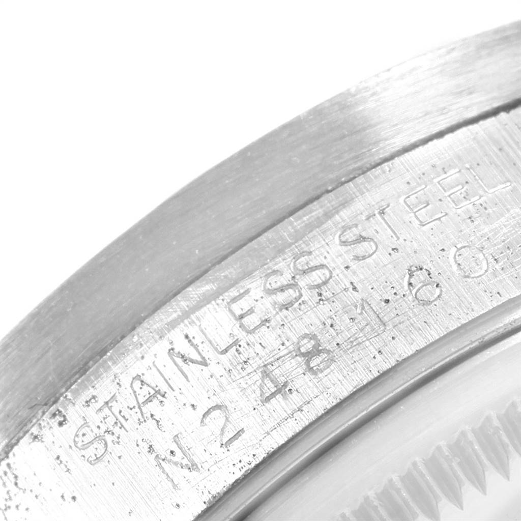 This close-up image shows the stainless steel bezel and engraved serial number of a Rolex Date 15210 Men's Stainless Steel Silver Dial 15210 Men's Stainless Steel Silver Dial model watch.