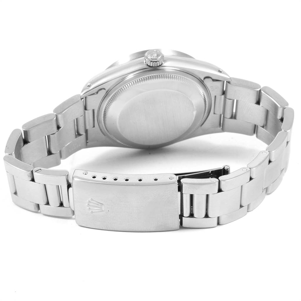 The image shows the back of a Rolex Date 15210 Men's Stainless Steel Silver Dial 15210 Men's Stainless Steel Silver Dial model watch, highlighting its case back and metal bracelet with the clasp open.