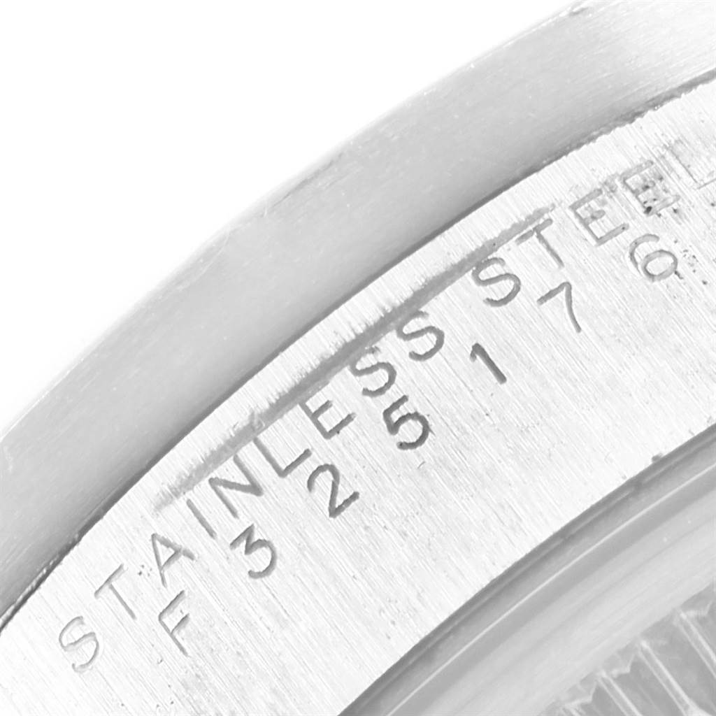 The image shows an angled close-up of the stainless steel casing and engraving of a Rolex Date 15210 Men's Stainless Steel Pink Dial 15210 Men's Stainless Steel Pink Dial model watch.