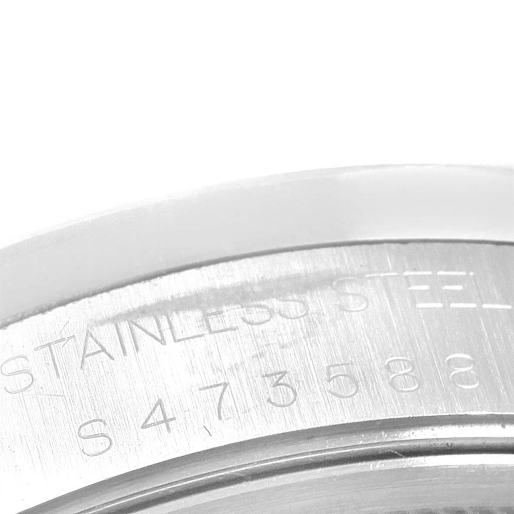 This close-up image shows the serial number engraving on the stainless steel caseback of a Rolex Date 15210 Men's Stainless Steel Silver Dial 15210 Men's Stainless Steel Silver Dial model watch.