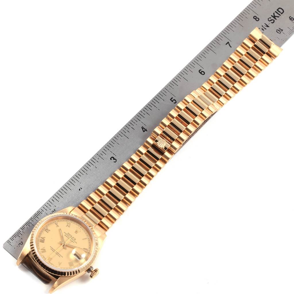 The image shows a Rolex Date 16238 Men's Yellow Gold Champagne Dial 16238 Men's Yellow Gold Champagne Dial model watch laid flat next to a ruler, displaying the watch face and full bracelet.