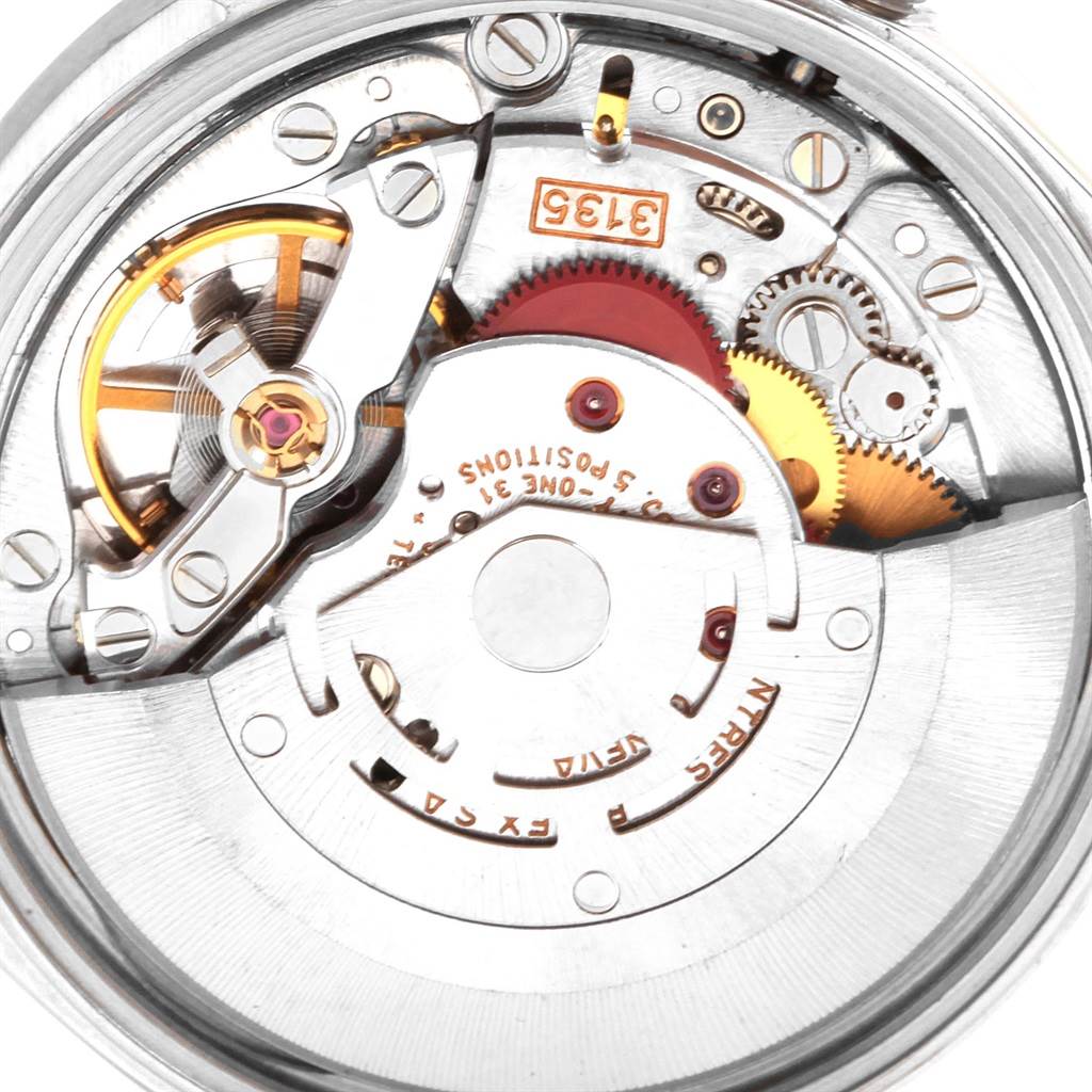 This image shows the internal mechanism of a Rolex Date 15210 Men's Stainless Steel Silver Dial 15210 Men's Stainless Steel Silver Dial model watch, showcasing gears and the rotor.