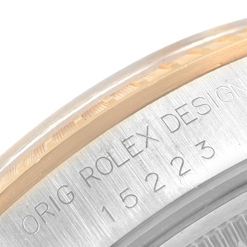 The image shows a close-up of the engraved side of a Date model watch by Rolex, highlighting the serial and design numbers.