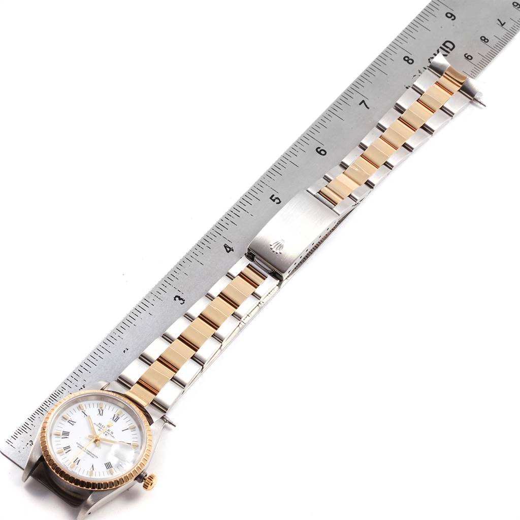 The image shows a Rolex Date 15223 Men's Steel and Gold (two tone) White Dial 15223 Men's Steel and Gold (two tone) White Dial model watch, fully extended, next to a ruler for measurement.