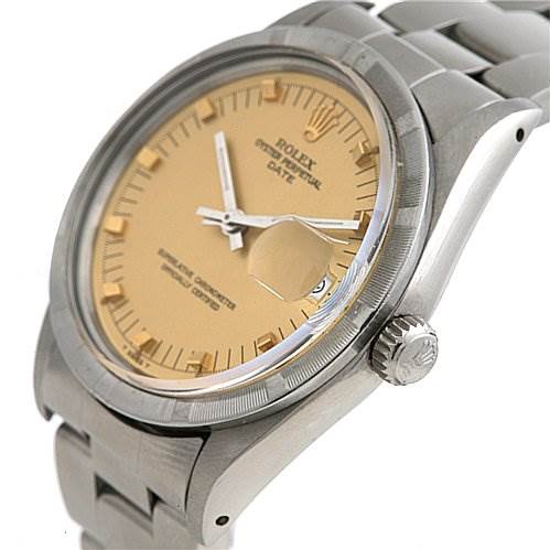 The image shows a close-up angled view of a Rolex Date 15010 Men
s Stainless Steel Champagne Dial 15010 Men
s Stainless Steel Champagne Dial watch displaying its dial, crown, and part of the bracelet.