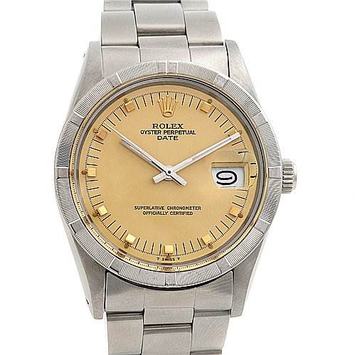 The image shows a front view of a Rolex Oyster Perpetual Date watch with a yellow dial, date window, and silver metal bracelet.