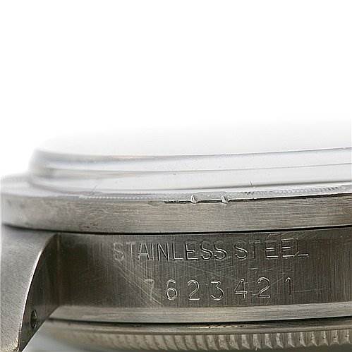 This image shows a close-up of the side of a Rolex Date 15010 Men
s Stainless Steel Champagne Dial 15010 Men
s Stainless Steel Champagne Dial model watch, specifically highlighting the serial number and "Stainless Steel" engraving.