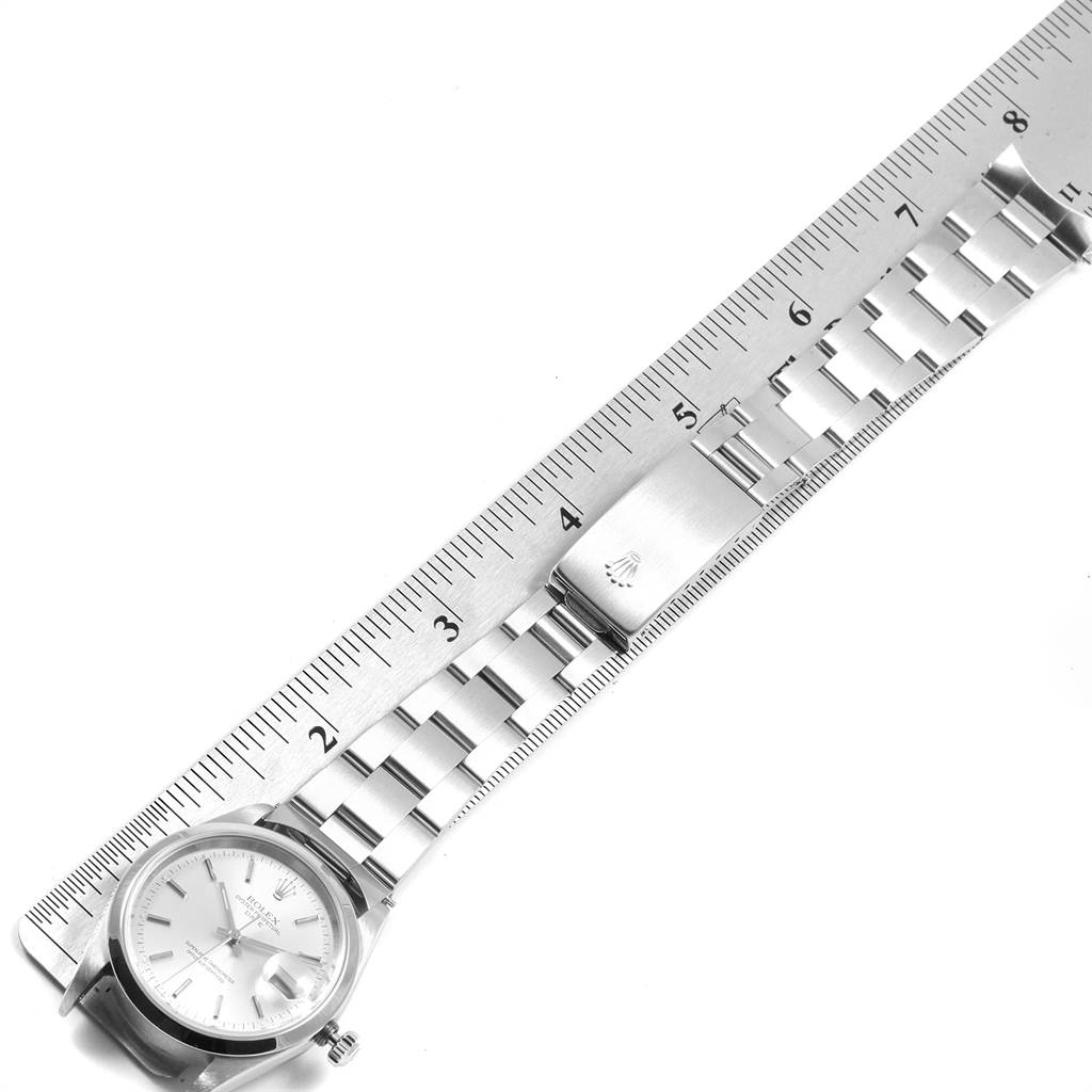 The image shows a Rolex Date 15200 Men's Stainless Steel Silver Dial 15200 Men's Stainless Steel Silver Dial model watch from a top-down angle, highlighting its face and metal bracelet next to a ruler for measurement.