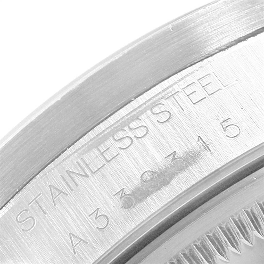 This close-up image shows the stainless steel case back of a Rolex Date 15210 Men's Stainless Steel Black Dial 15210 Men's Stainless Steel Black Dial model watch.