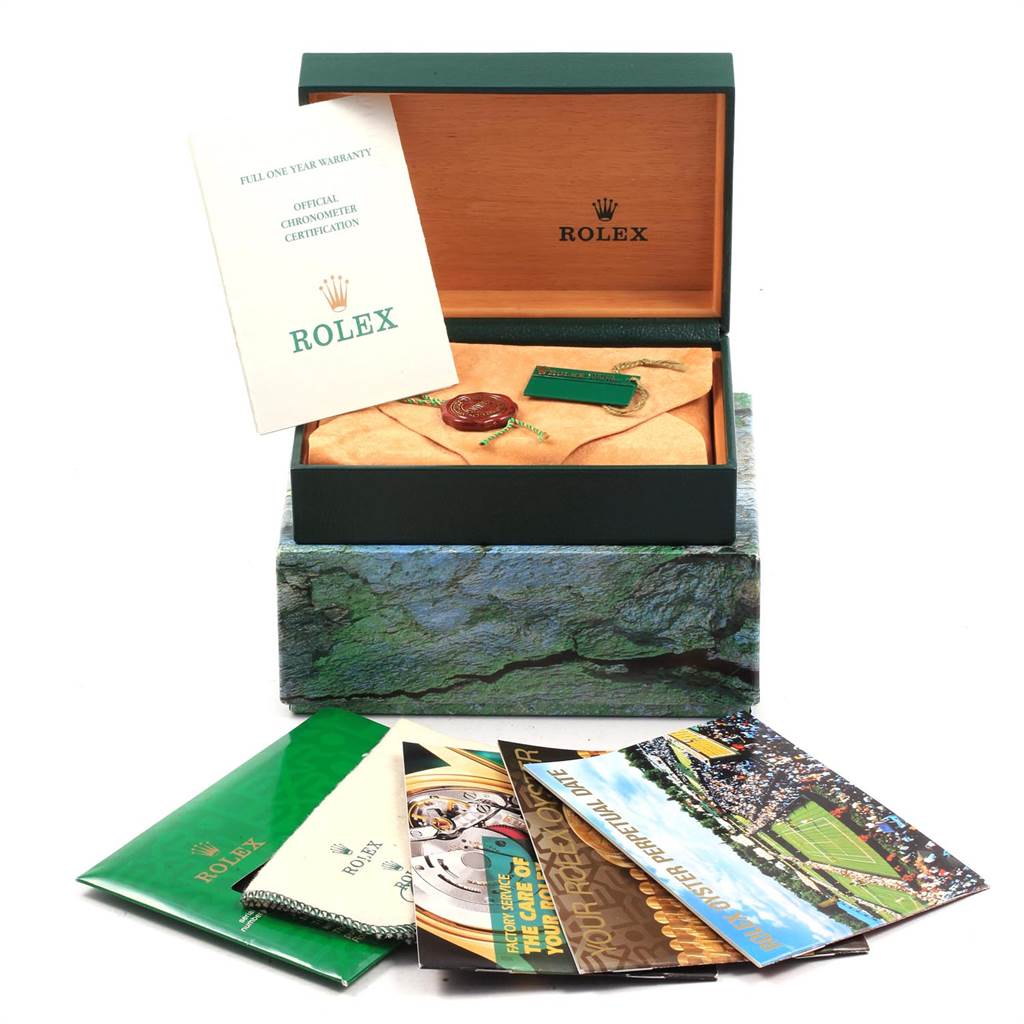 The image shows the packaging and accessories for a Rolex Date 15210 Men's Stainless Steel Black Dial 15210 Men's Stainless Steel Black Dial model watch, including the warranty, certification, tags, and brochures.