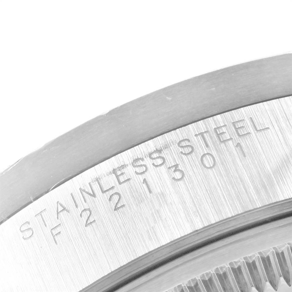 The image shows a close-up angle of the stainless steel case back of a Rolex Date 15210 Men's Stainless Steel Silver Dial 15210 Men's Stainless Steel Silver Dial model watch, including part of the serial number.