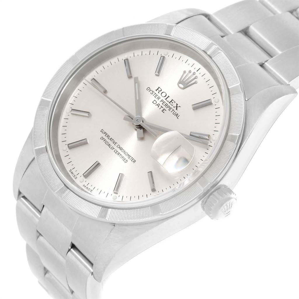 The image shows a Rolex Oyster Perpetual Date model watch from an angled, close-up view, highlighting its face, bezel, and part of the bracelet.