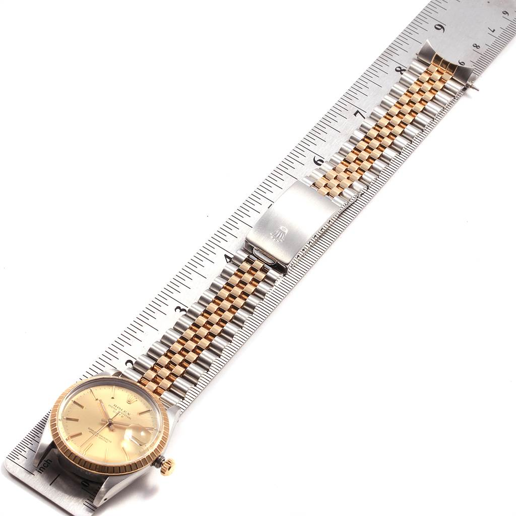 This image shows a Rolex Date 15053 Men's Steel and Gold (two tone) Champagne Dial 15053 Men's Steel and Gold (two tone) Champagne Dial model watch, flat on a ruler, displaying the face, bezel, bracelet, and clasp.