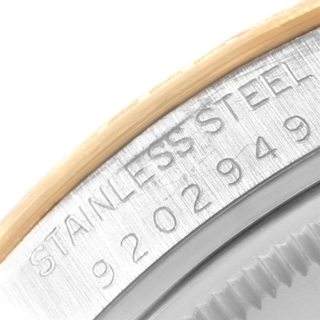 This is a close-up view of the case edge and engraving on the Rolex Date 15053 Men's Steel and Gold (two tone) Champagne Dial 15053 Men's Steel and Gold (two tone) Champagne Dial model watch, showing the "STAINLESS STEEL" text and serial number.