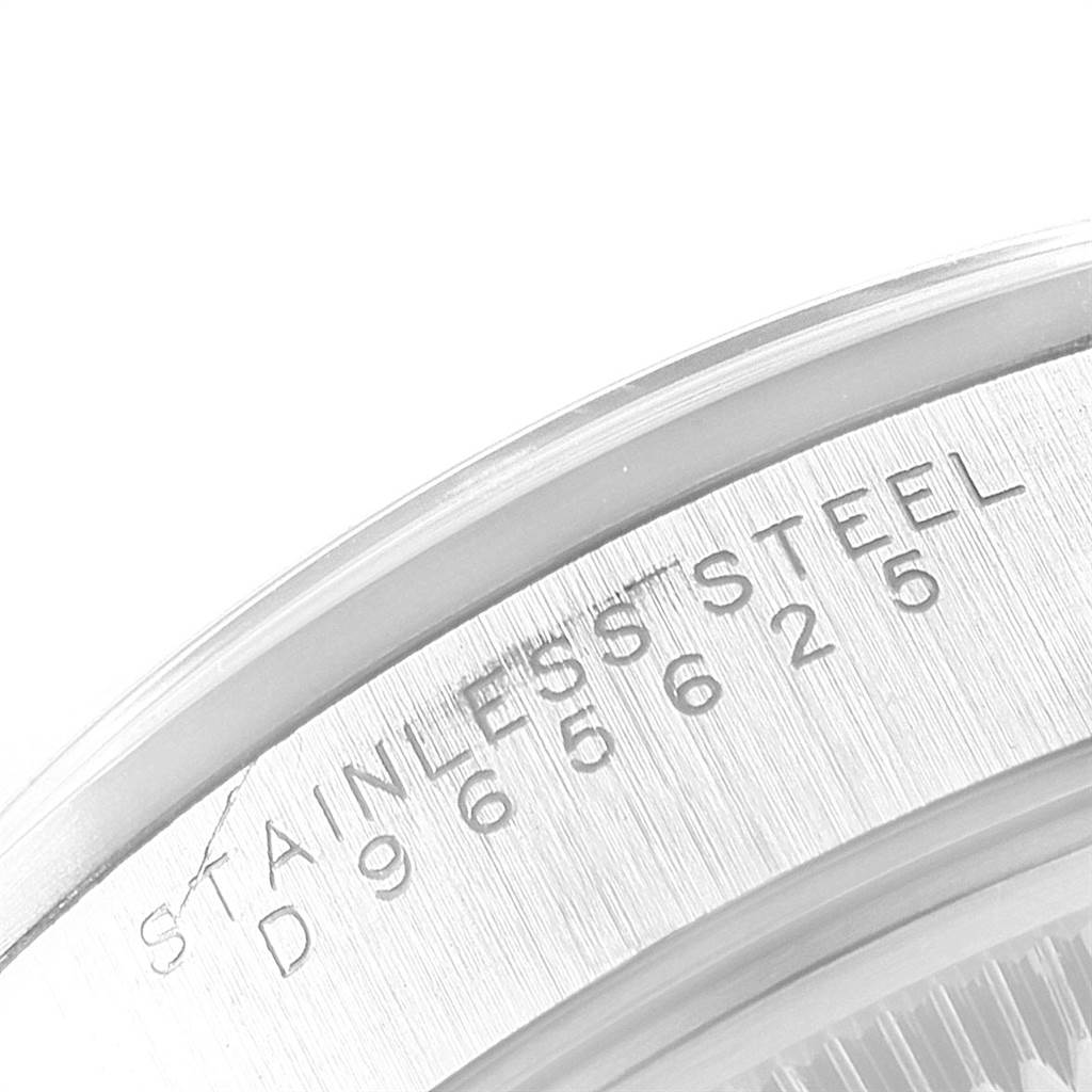 This image shows a close-up of the serial number and "STAINLESS STEEL" engraving on the edge of a Rolex Date 15200 Men's Stainless Steel Silver Dial 15200 Men's Stainless Steel Silver Dial watch.