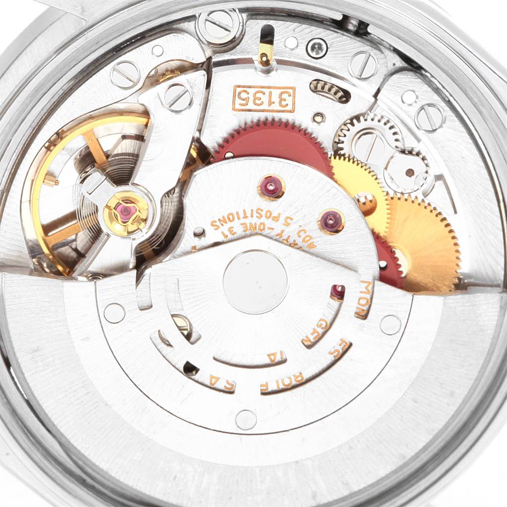 This image shows an internal view of a Rolex Date 15210 Men's Stainless Steel White Dial 15210 Men's Stainless Steel White Dial model watch movement, highlighting gears and intricate components.