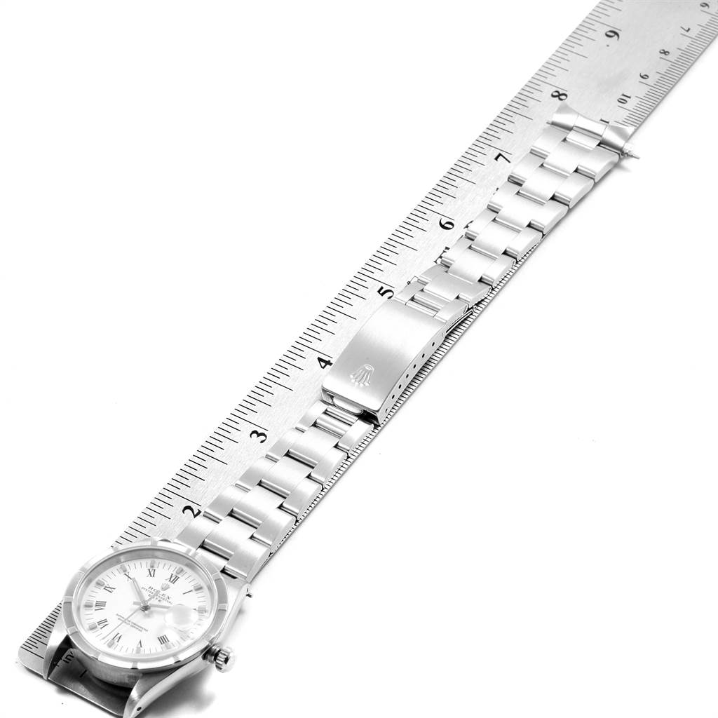 The image shows a Rolex Date 15210 Men's Stainless Steel White Dial 15210 Men's Stainless Steel White Dial model watch laid flat beside the bracelet and clasp, along with a ruler for size reference.