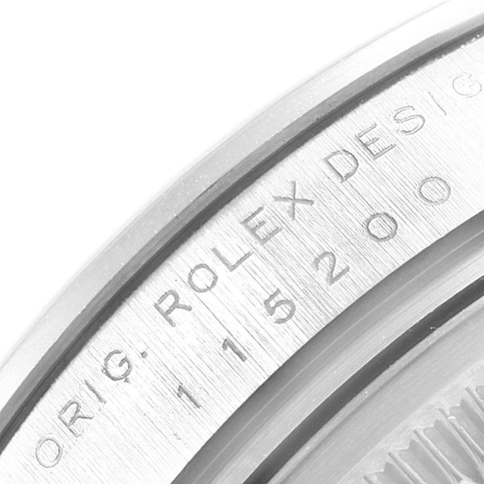 This close-up image shows the model number engraving on the Rolex Date 115200 Men's Stainless Steel Pink Dial 115200 Men's Stainless Steel Pink Dial watch bezel.