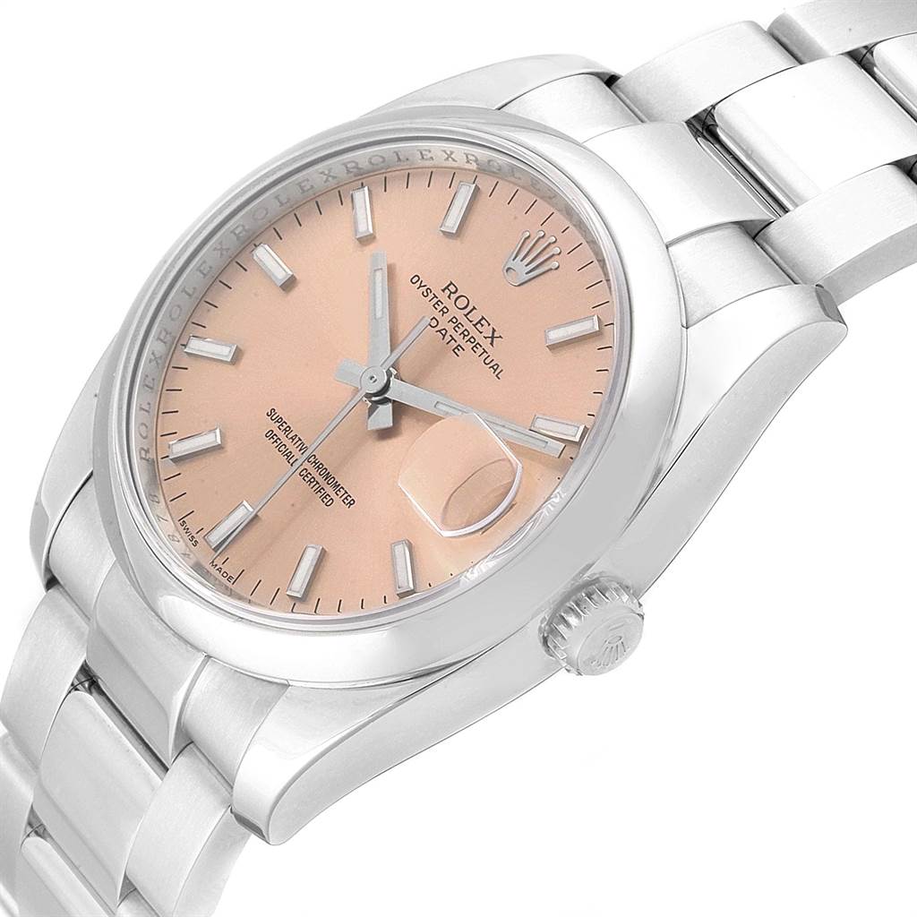 The Rolex Date 115200 Men's Stainless Steel Pink Dial 115200 Men's Stainless Steel Pink Dial model watch is shown at a slight angle, displaying its dial, case, bracelet, and crown.