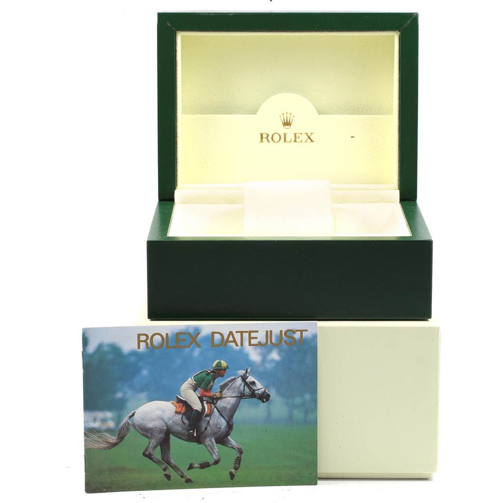 The image shows an open green Rolex box for the Datejust model along with a booklet featuring a person on a horse.
