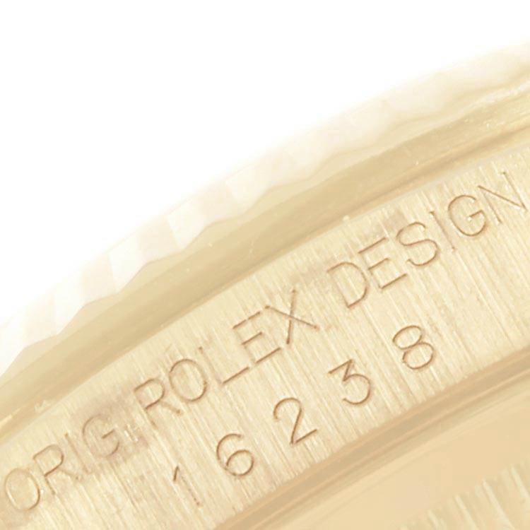 This image shows a close-up of the engraved inner bezel of a Rolex Date 16238 Men's Yellow Gold Champagne Dial 16238 Men's Yellow Gold Champagne Dial model watch.