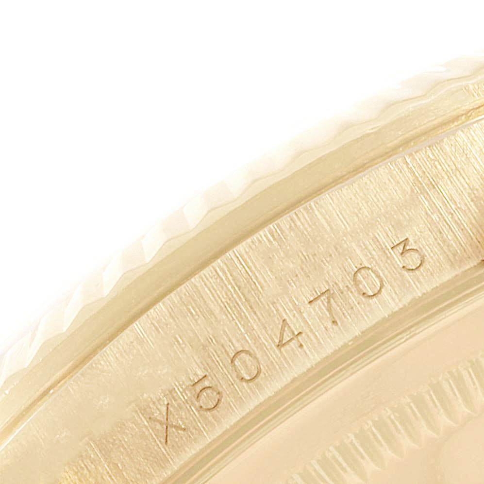 This close-up image shows the serial number engraved on the case of a Rolex Date 16238 Men's Yellow Gold Champagne Dial 16238 Men's Yellow Gold Champagne Dial model watch.