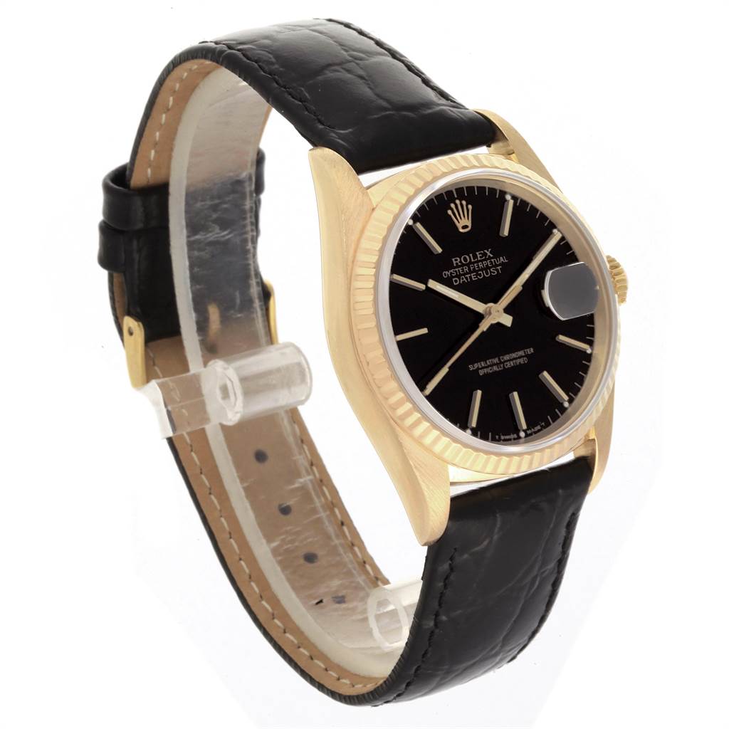 The Rolex Date 16238 Men's Yellow Gold Champagne Dial 16238 Men's Yellow Gold Champagne Dialjust watch is shown at a 3/4 angle, highlighting its black leather strap, gold case, and black dial.