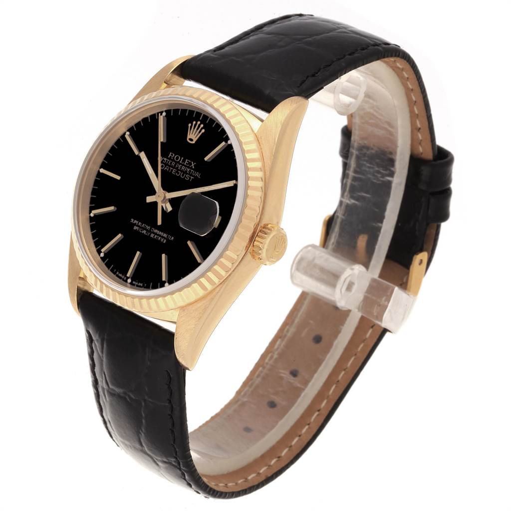 This image shows a Rolex Date 16238 Men's Yellow Gold Champagne Dial 16238 Men's Yellow Gold Champagne Dialjust watch at a slight angle, highlighting its black dial, gold case, fluted bezel, and leather strap.