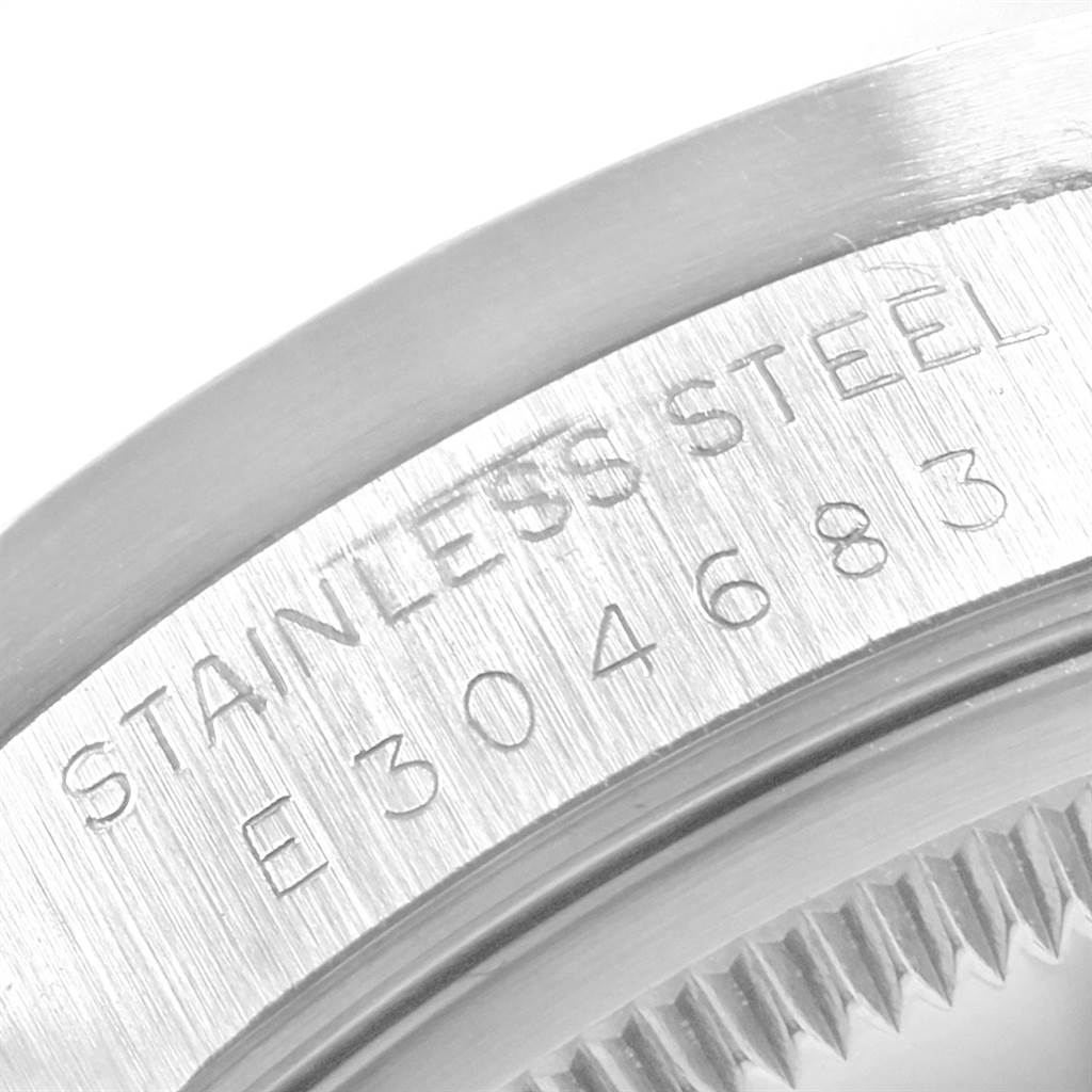 This image shows the engraved caseback and part of the fluted bezel of a Rolex Date 15210 Men's Stainless Steel Silver Dial 15210 Men's Stainless Steel Silver Dial model watch, focusing on the stainless steel marking.
