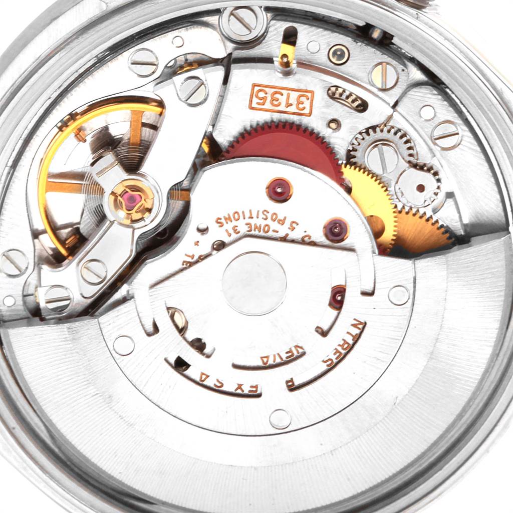 This image shows a close-up of the internal mechanism of a Rolex Date 15210 Men's Stainless Steel Silver Dial 15210 Men's Stainless Steel Silver Dial model, including gears and the balance wheel.