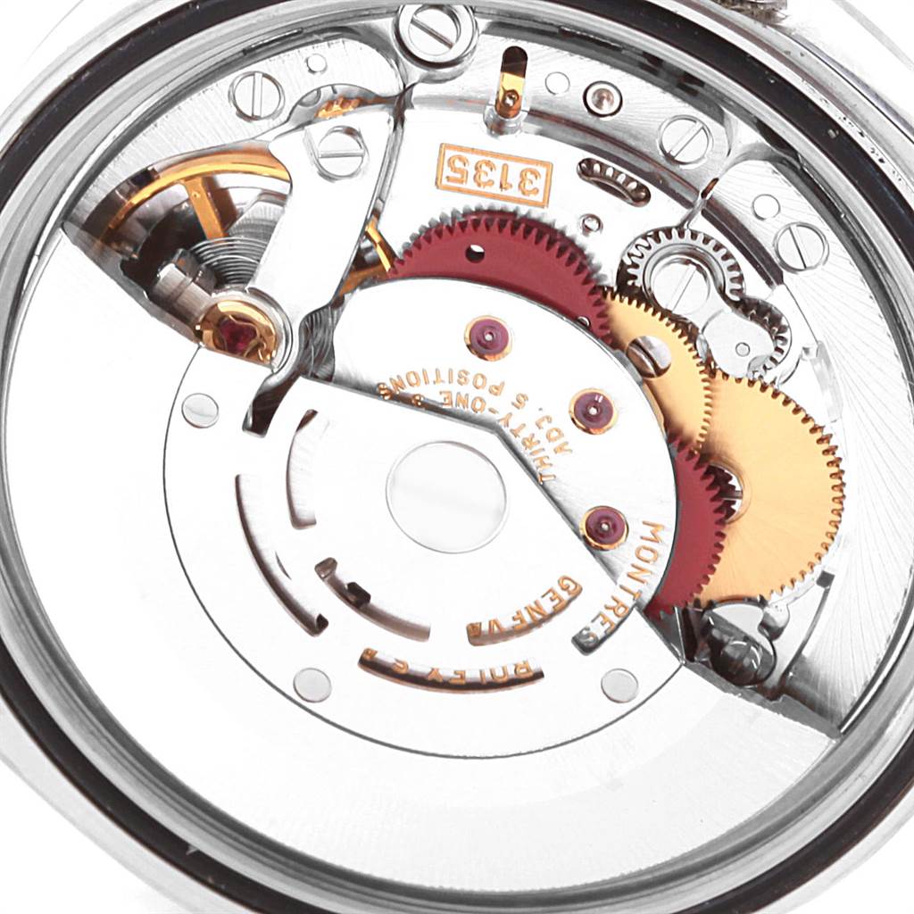 The image shows a close-up of the movement of a Rolex Date 16200 Men's Stainless Steel White Dial 16200 Men's Stainless Steel White Dial model watch, highlighting the gears and components.