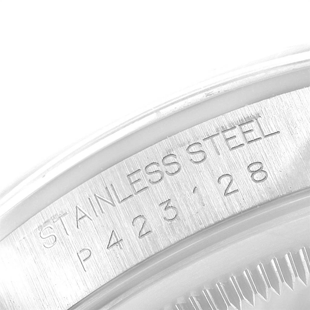 This image shows a close-up of the serial number and "Stainless Steel" engraving on the casing of a Rolex Date 16200 Men's Stainless Steel White Dial 16200 Men's Stainless Steel White Dial watch.