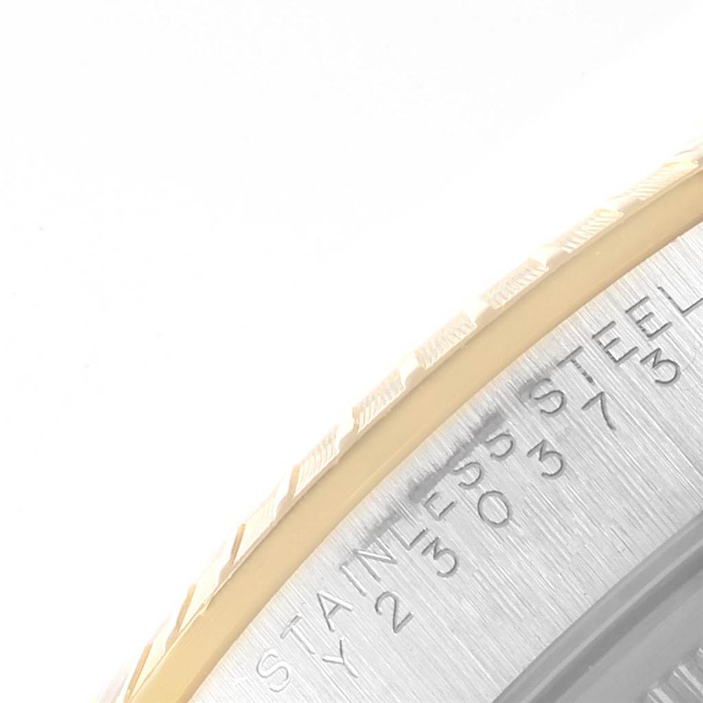 This is a close-up of the bezel and part of the case back of a Rolex Date 15223 Men's Steel and Gold (two tone) Blue Dial 15223 Men's Steel and Gold (two tone) Blue Dial model watch.