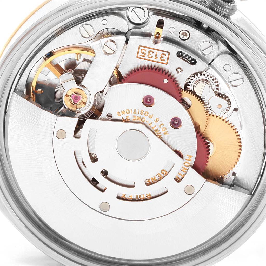 This is a close-up view of the Rolex Date 15223 Men's Steel and Gold (two tone) Blue Dial 15223 Men's Steel and Gold (two tone) Blue Dial model's movement, showcasing its intricate gears and mechanisms.