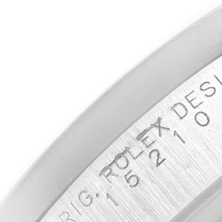The image shows a close-up of the engraving on the side of a Rolex Date 15210 Men's Stainless Steel White Dial 15210 Men's Stainless Steel White Dial model watch bezel or inner case.