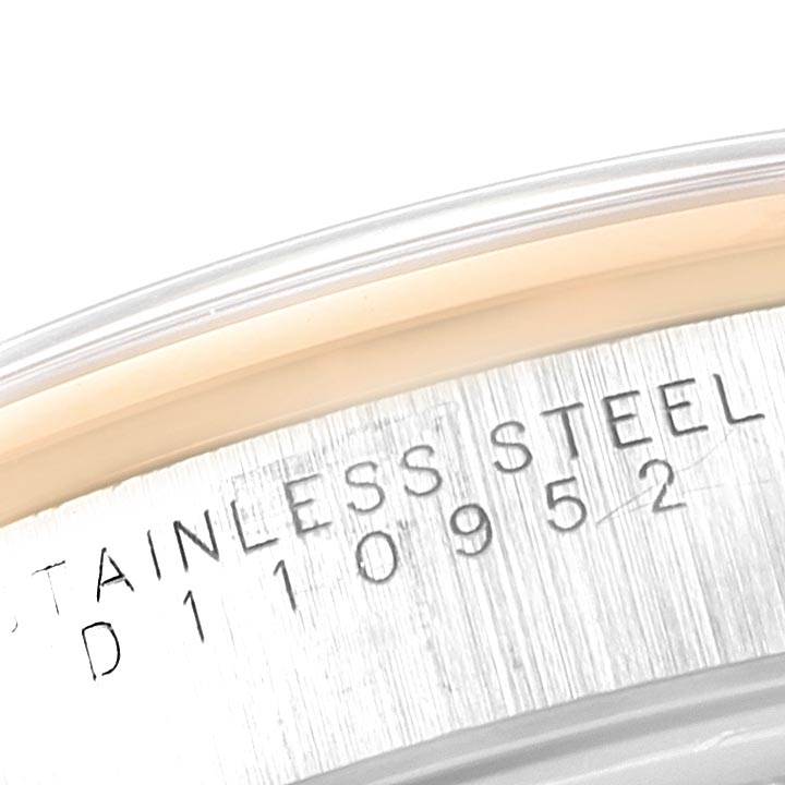 This image shows a close-up of the serial number engraving on the side of a stainless steel Rolex Date 15203 Men's Steel and Gold (two tone) Grey Dial 15203 Men's Steel and Gold (two tone) Grey Dial watch.
