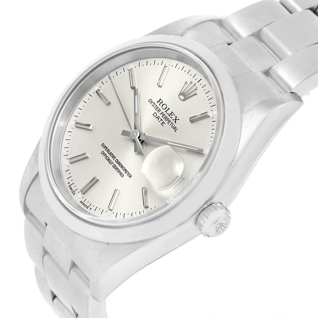 The image shows a Rolex Oyster Perpetual Date watch at a slight angle, highlighting the face, bezel, crown, and part of the bracelet.