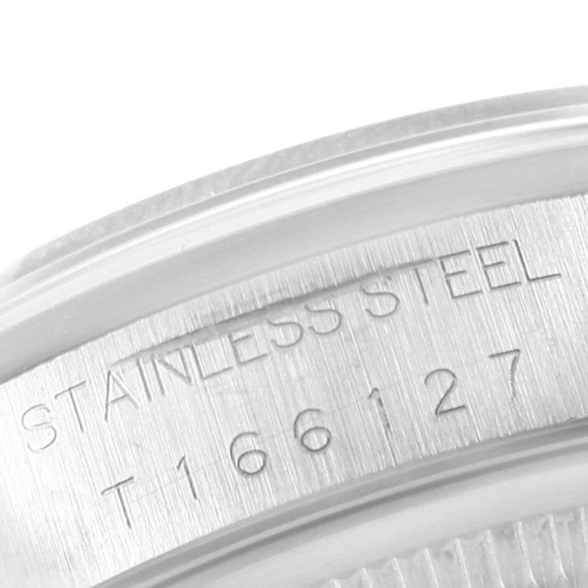 This close-up image shows the stainless steel serial number engraving on the case of a Rolex Date 15200 Men's Stainless Steel Silver Dial 15200 Men's Stainless Steel Silver Dial model watch.