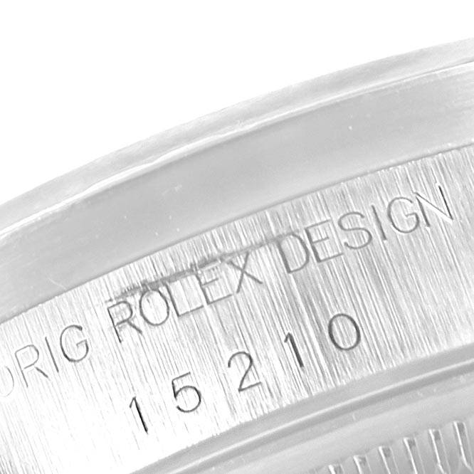 The image shows a close-up angle of the engraved text on the case of a Rolex Date 15210 Men's Stainless Steel Black Dial 15210 Men's Stainless Steel Black Dial model watch.