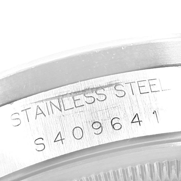 The image shows a close-up of the stainless steel case back with engraved serial number of a Rolex Date 15210 Men's Stainless Steel Black Dial 15210 Men's Stainless Steel Black Dial model watch.