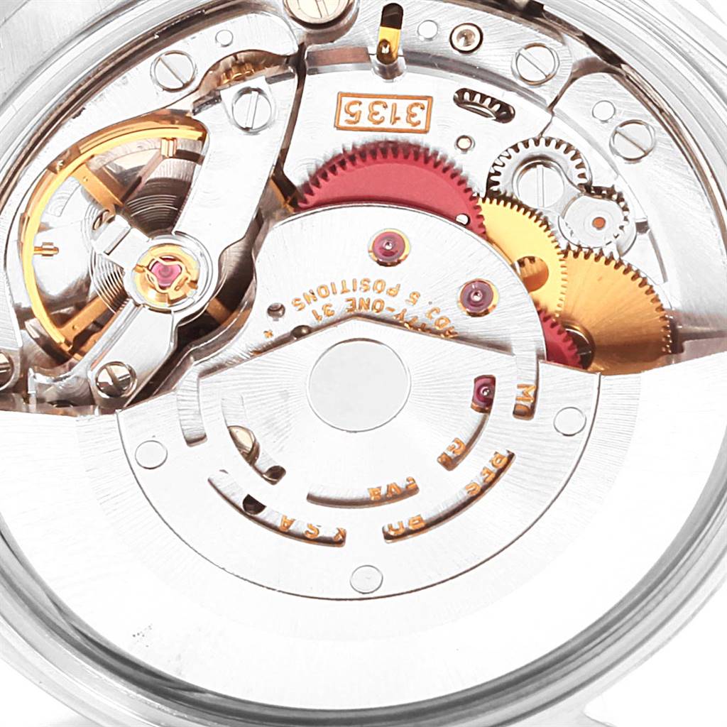 The image shows a close-up of the internal mechanism of a Rolex Date 15210 Men's Stainless Steel Black Dial 15210 Men's Stainless Steel Black Dial model watch, highlighting gears and mechanical components.