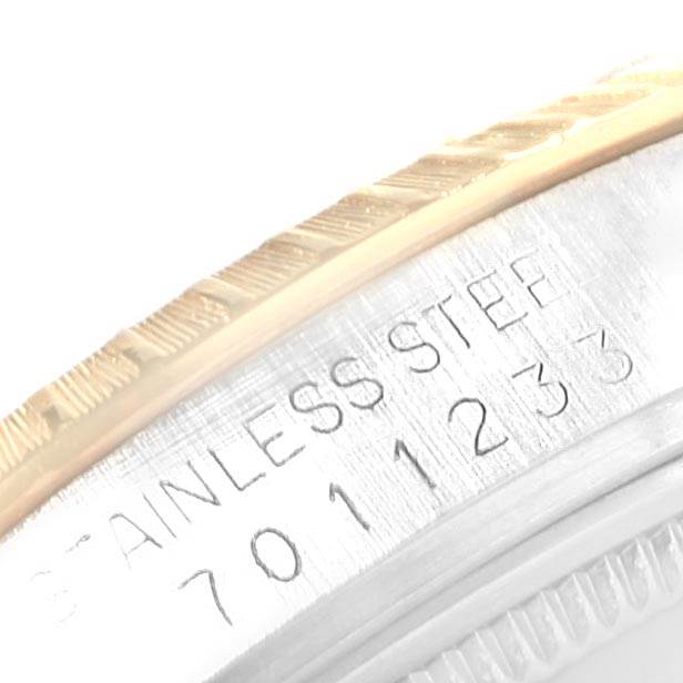 The image shows a close-up of the serial number and the edge of the bezel of a Rolex Date 15053 Men's Steel and Gold (two tone) Champagne Dial 15053 Men's Steel and Gold (two tone) Champagne Dial watch.